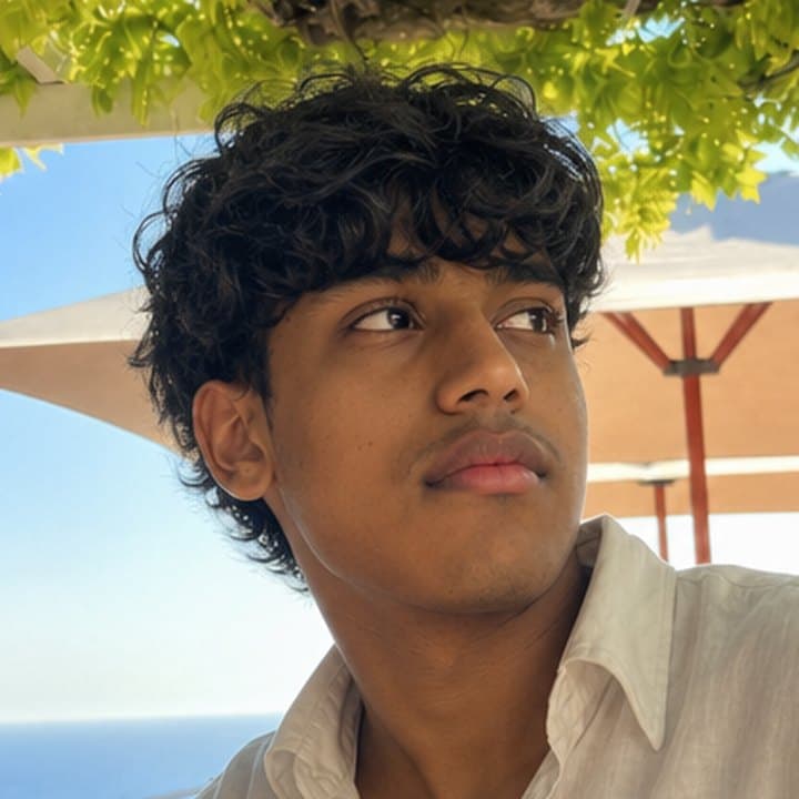 Geetesh outdoors beneath a tree